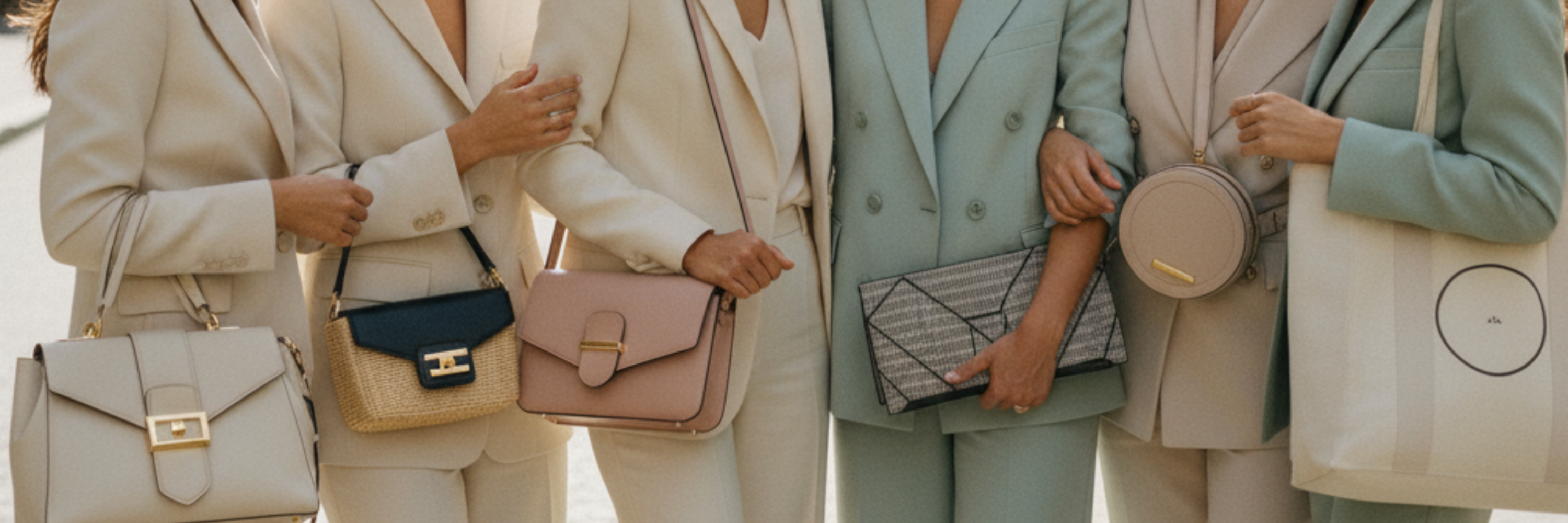 Retail display shelf with handbags, including totes, crossbody purses, and shoulder bags. 'Trending Now' sign above. Modern, well-lit store layout with a neutral color scheme.