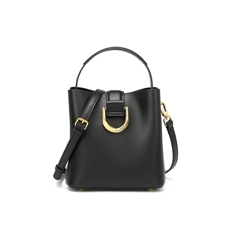 Black handbag with gold hardware on a white background