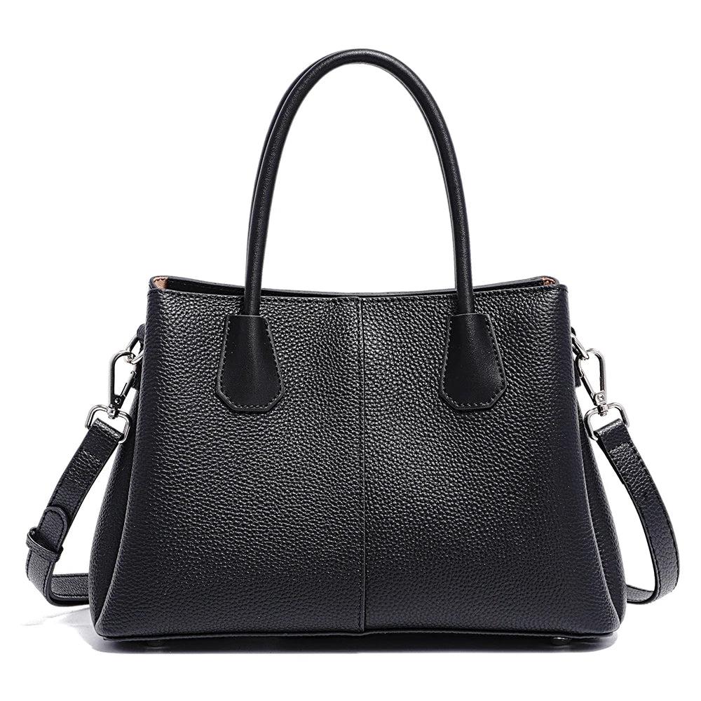 Black leather handbag with a shoulder strap on a white background