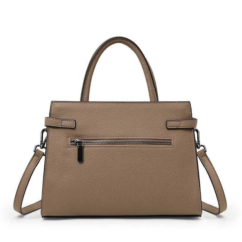 Brown handbag with a shoulder strap on a white background