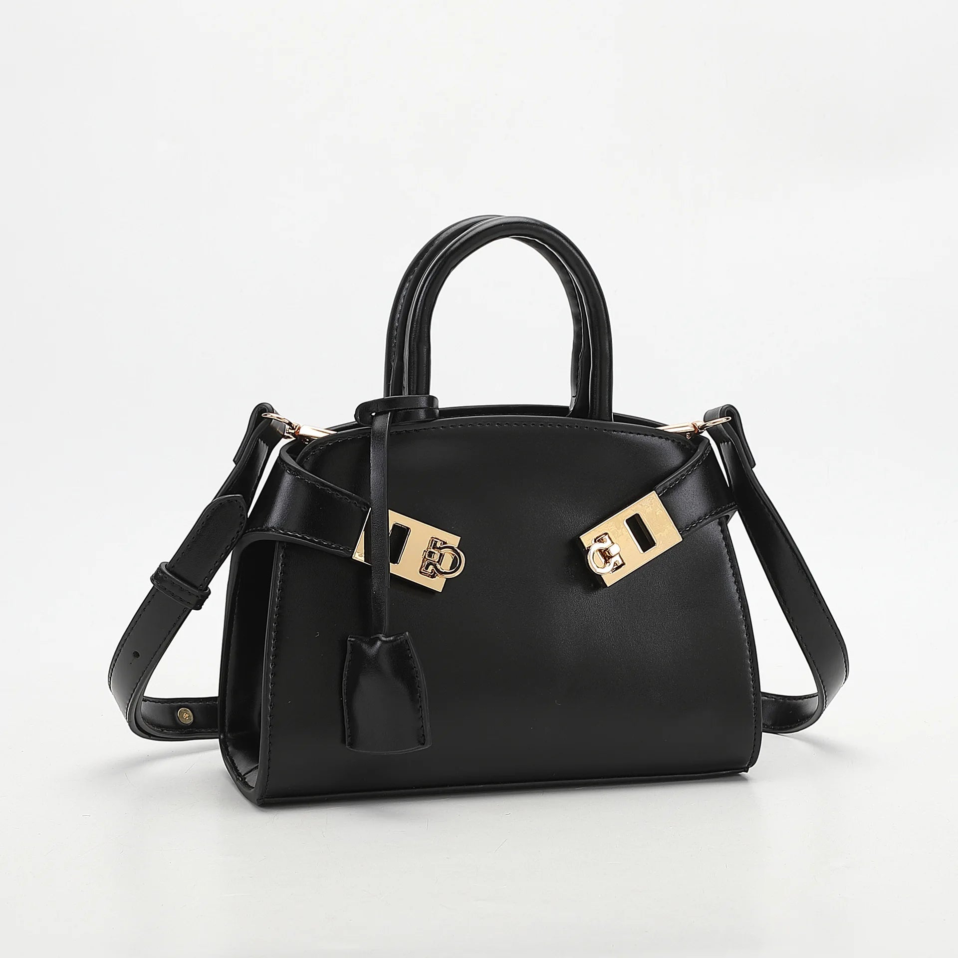 Black handbag with gold accents on a white background