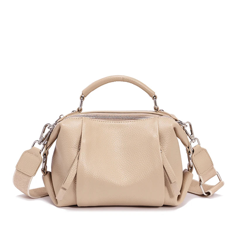 Beige handbag with a shoulder strap on a white background