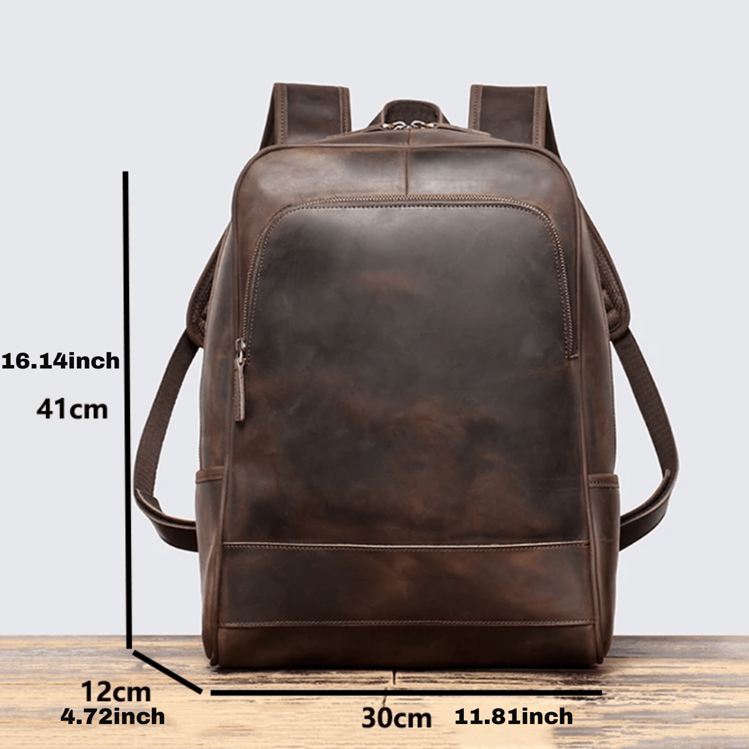 Brown leather backpack with measurements on a light gray background
