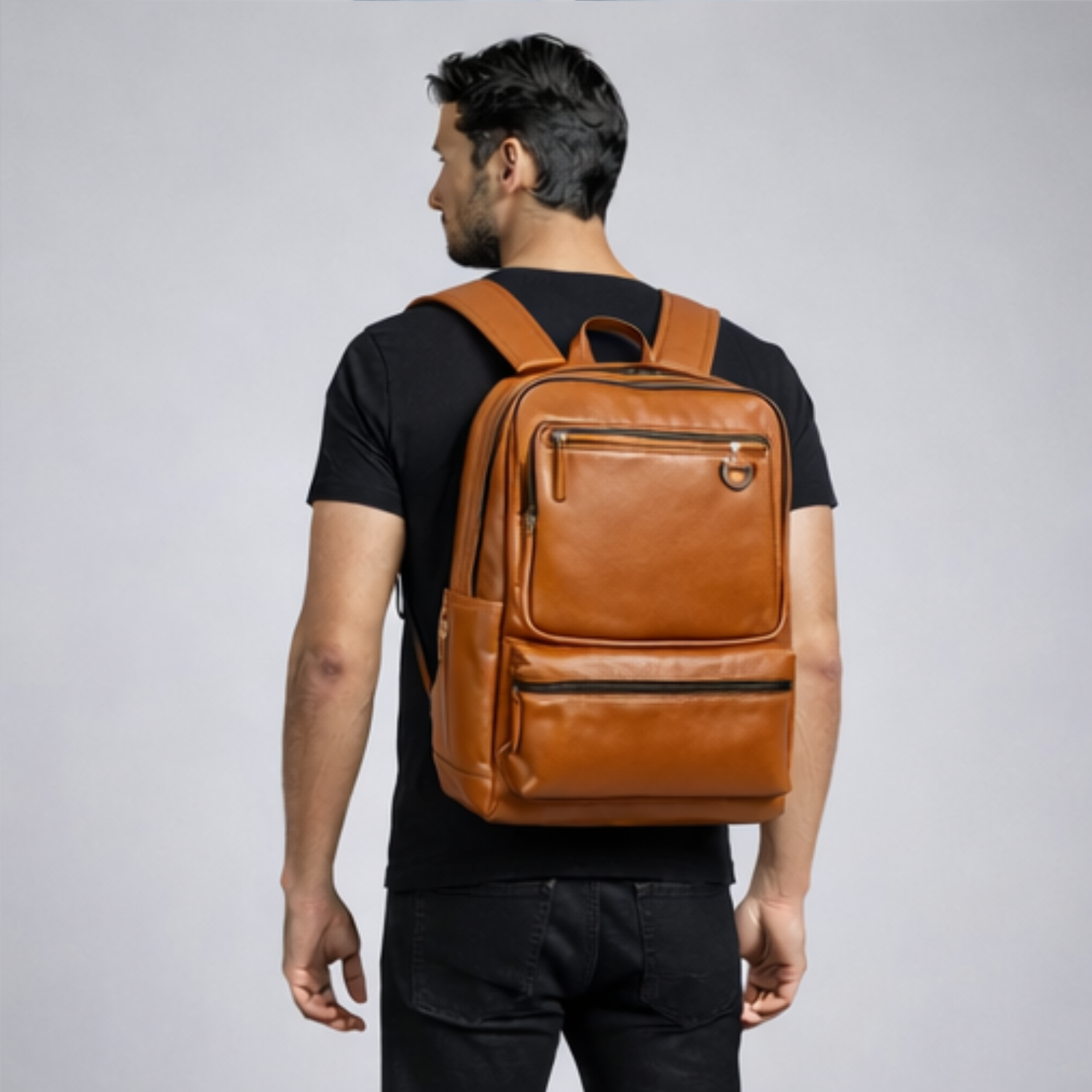 Man wearing a brown leather backpack on a plain background