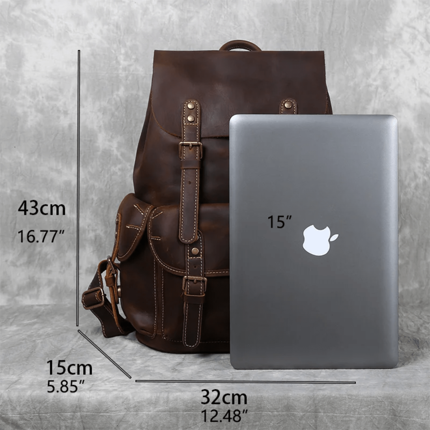 brwn backpack measurements comparing to 15 inch laptop on gray background