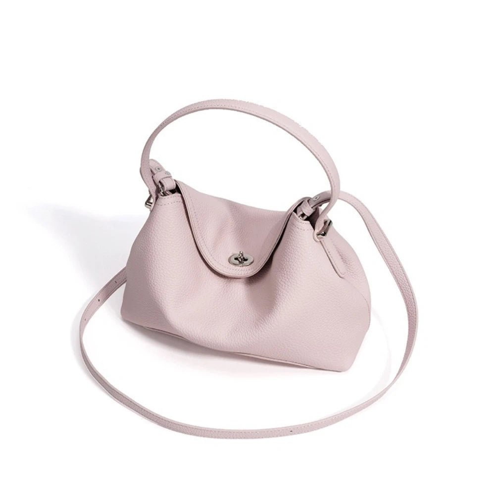 Pink handbag with a strap on a white background