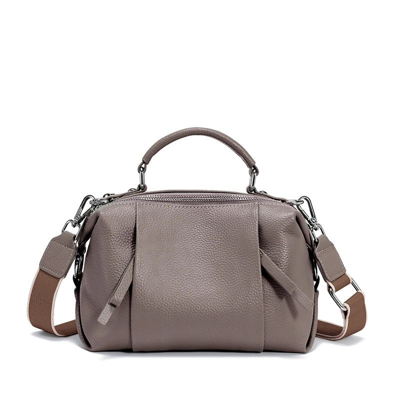 Gray handbag with a shoulder strap on a white background