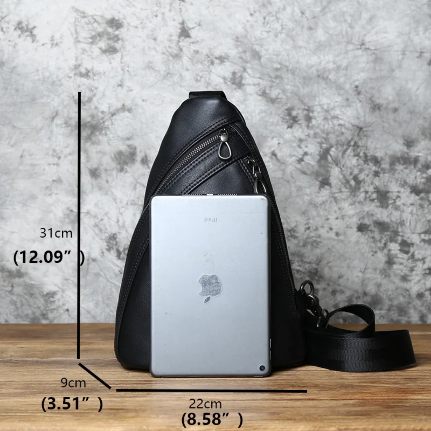 black chest bag with measurements and Ipad to compare