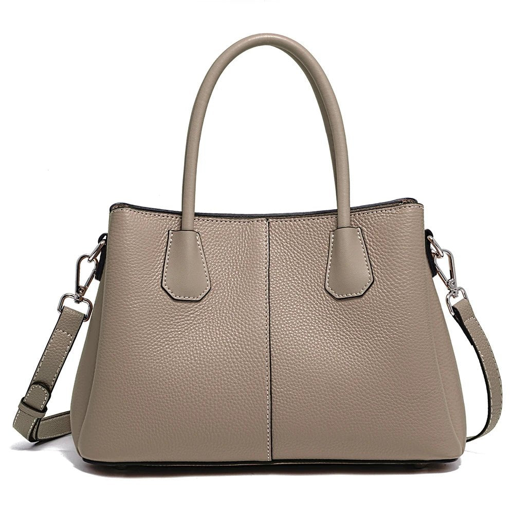 Beige handbag with a shoulder strap on a white background