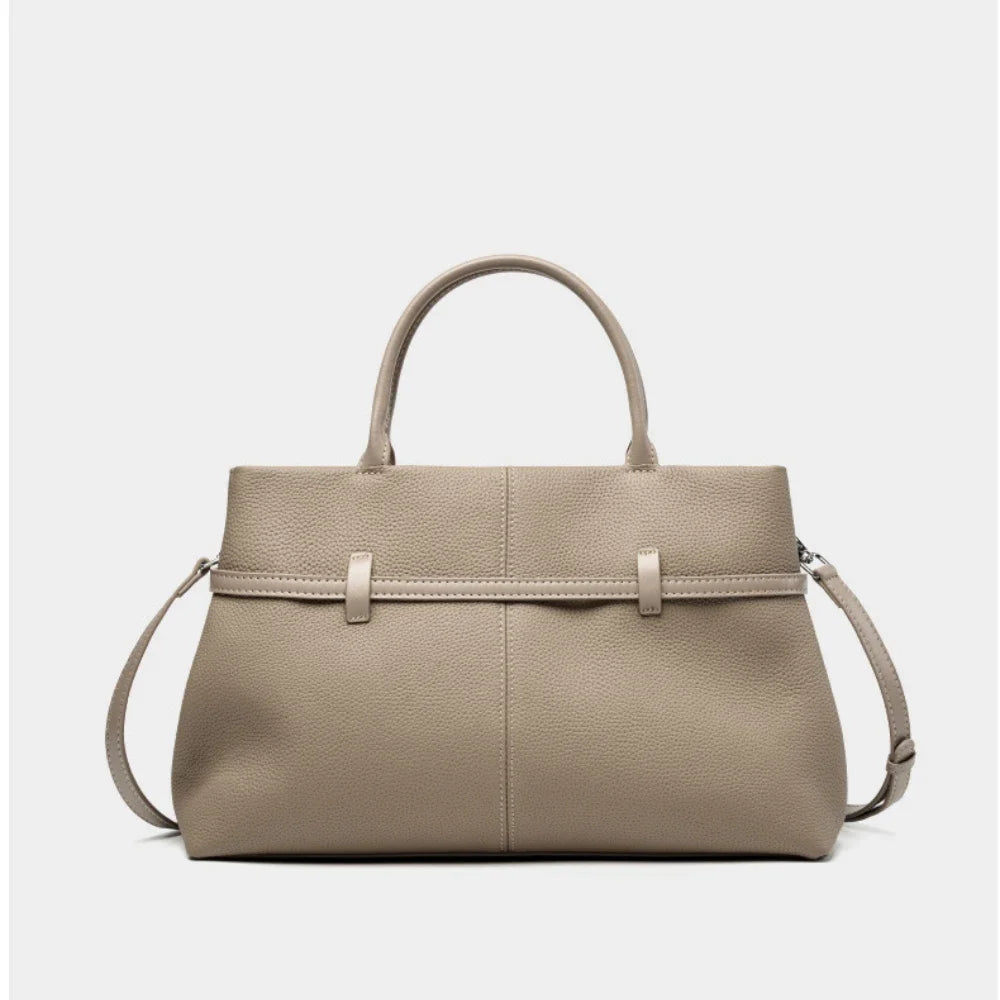 Beige handbag with a strap on a light gray background