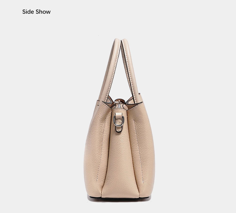 Beige handbag with a visible brand name on a light gray background