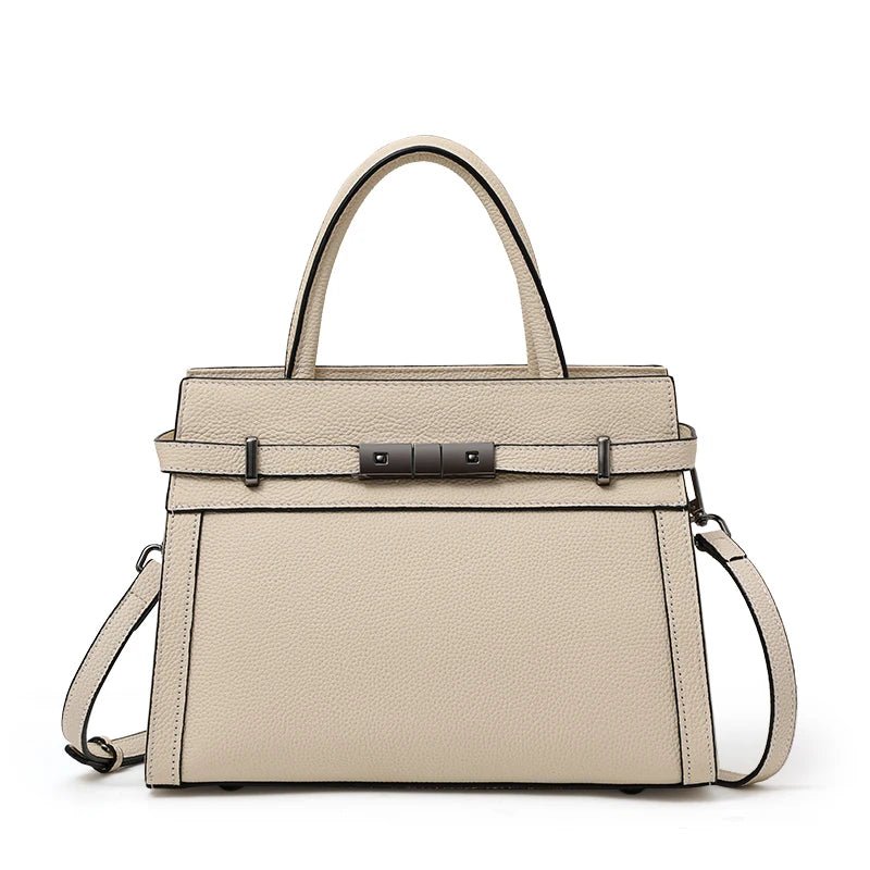 Beige handbag with black hardware on a white background