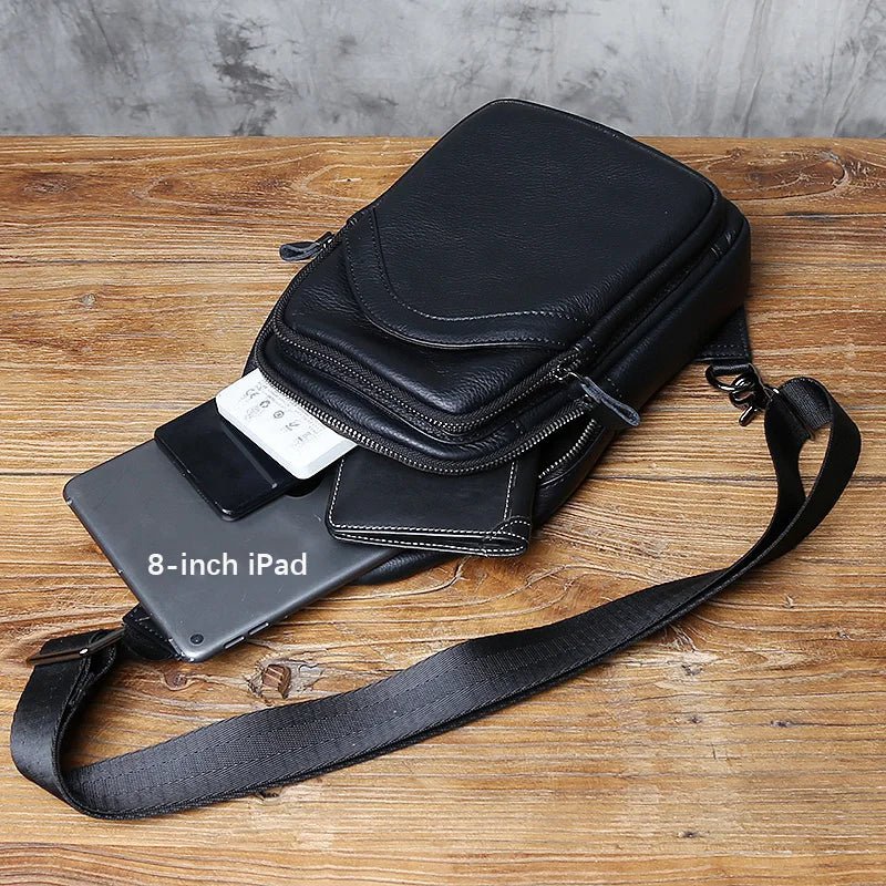 Black crossbody bag with 8-inch iPad on a wooden surface