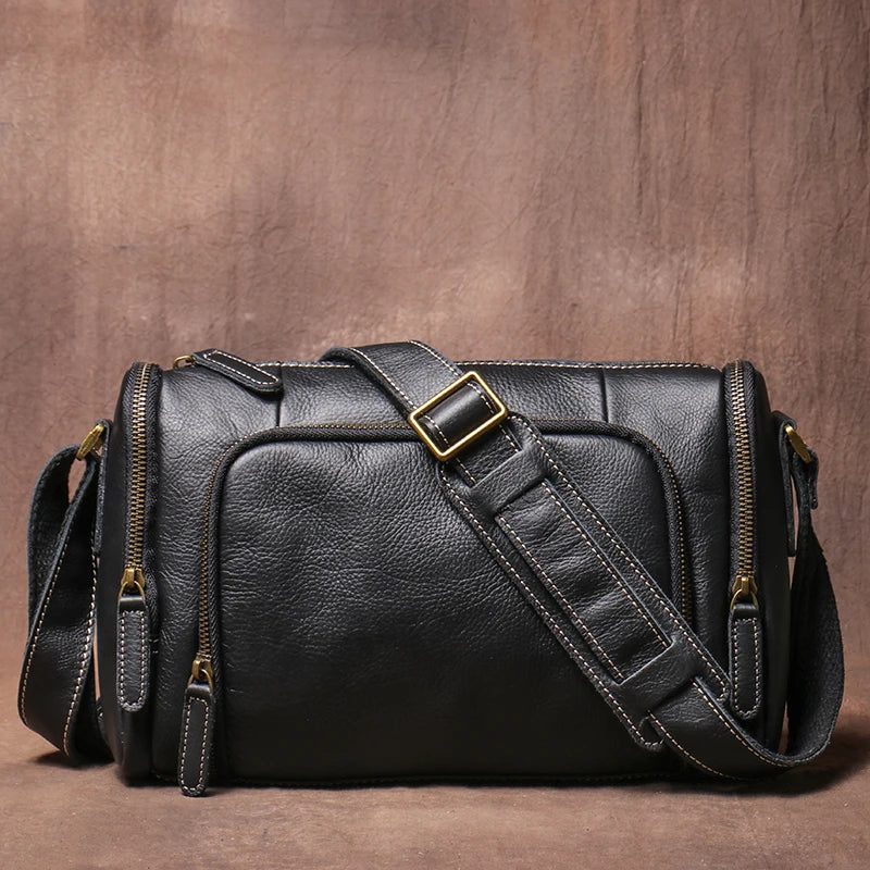 Black leather bag with gold hardware on a brown background