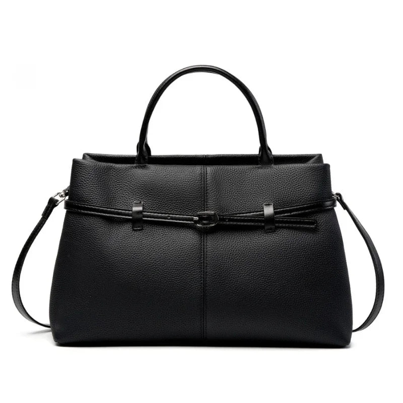 Black leather handbag with a strap on a white background