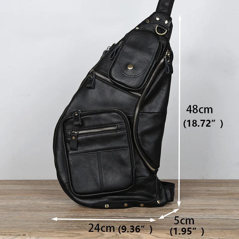 Black leather sling bag with measurements on a wooden surface and light gray background