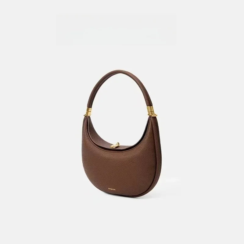 Brown handbag with gold accents on a light gray background