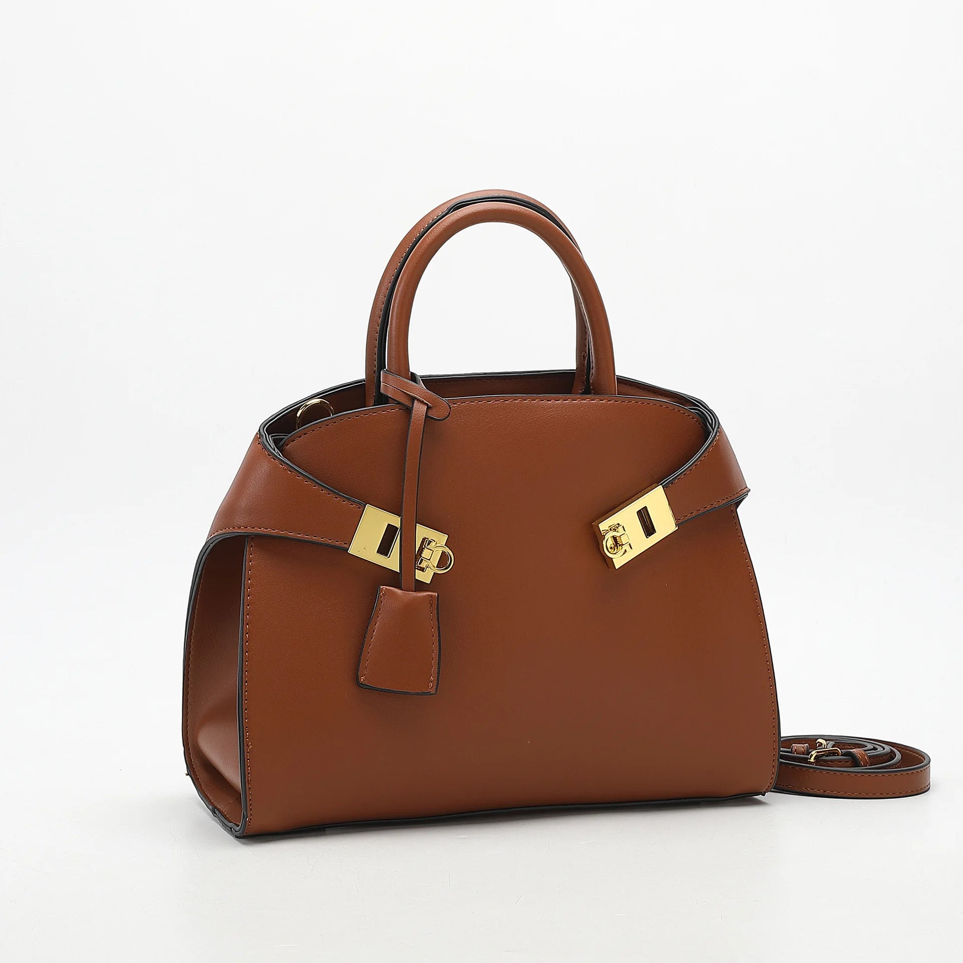 Brown handbag with gold hardware on a white background