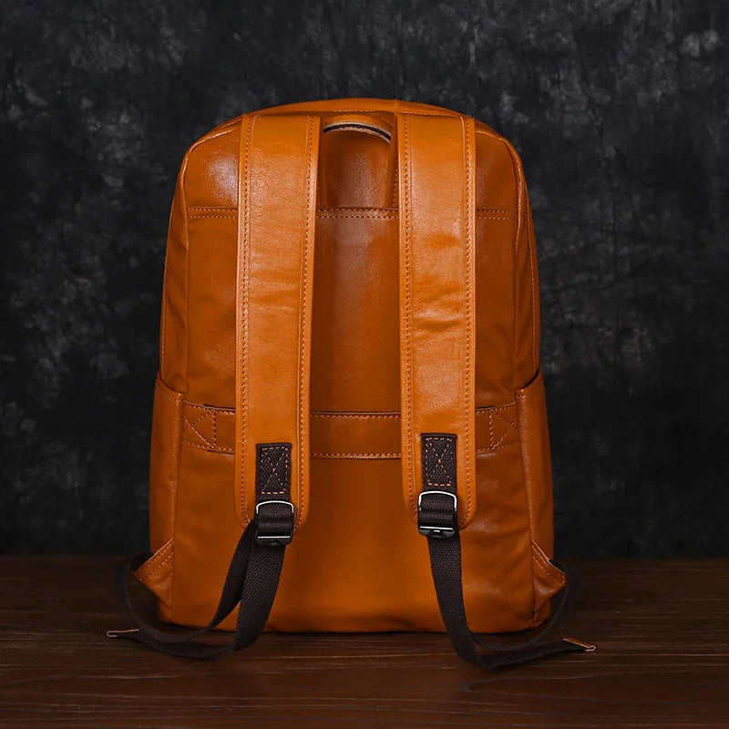 Brown leather backpack on a dark textured background