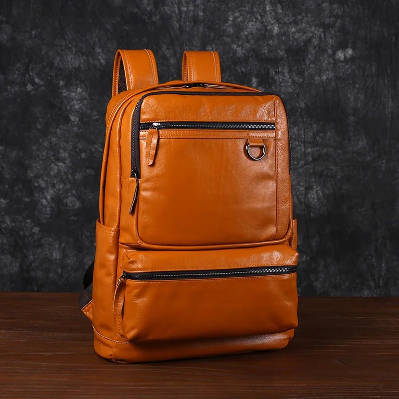 Brown leather backpack on a wooden surface with a dark textured background