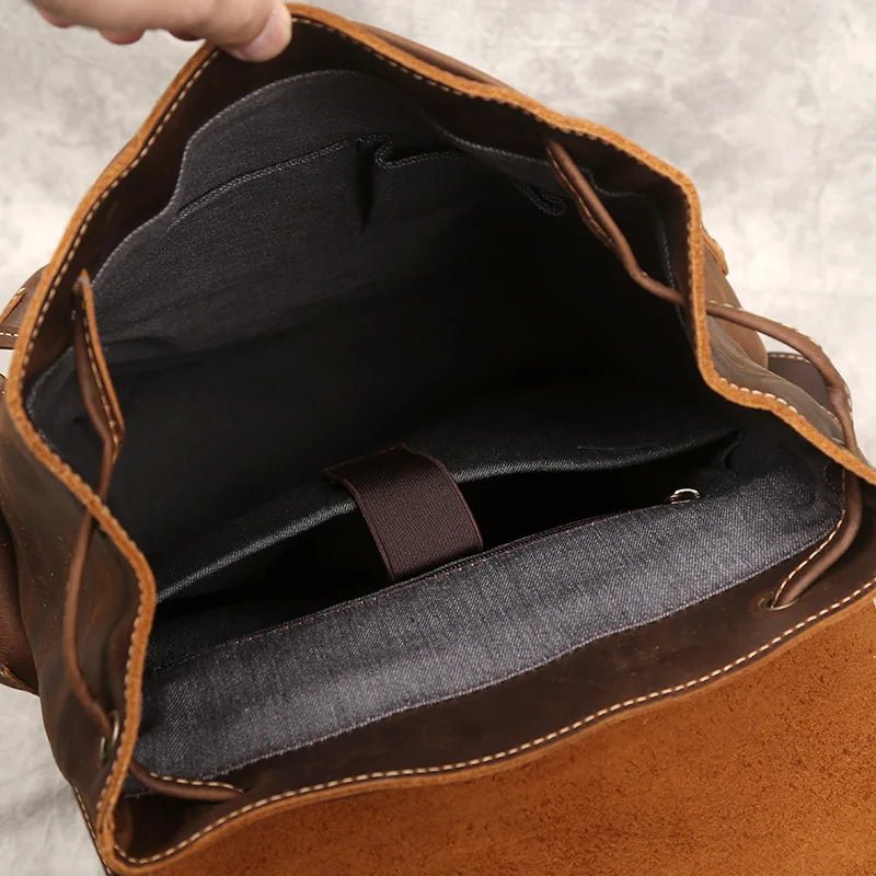 Brown leather bag with open front, showing black interior lining.