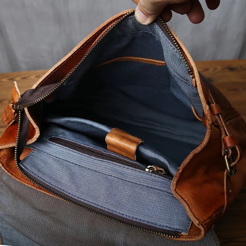 Brown leather bag with open zipper showing blue interior