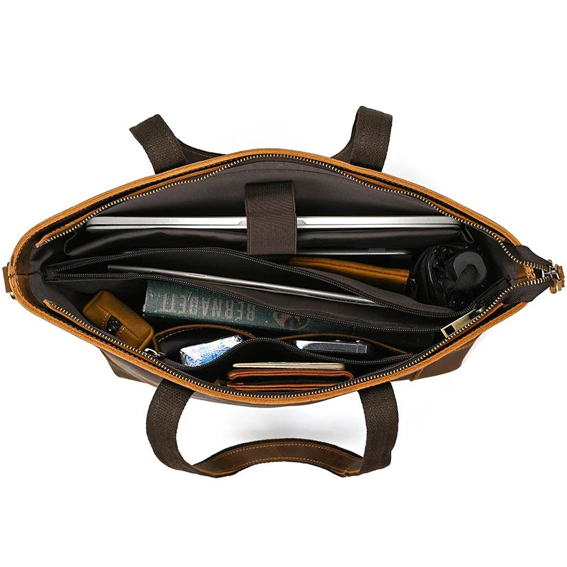 Brown leather briefcase with interior compartments on a white background