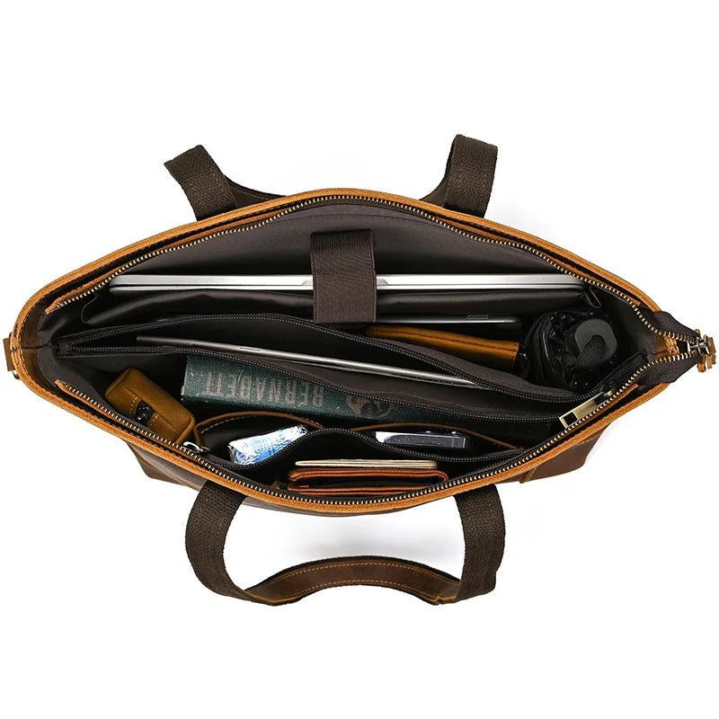 Brown leather briefcase with interior compartments on a white background