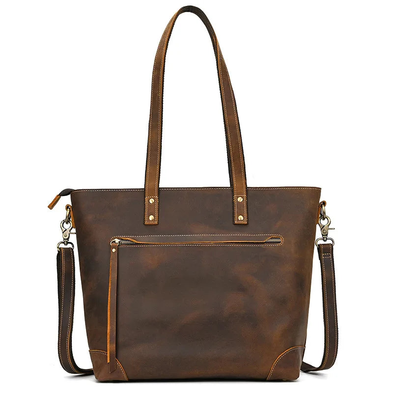 Brown leather tote bag with shoulder strap on a white background