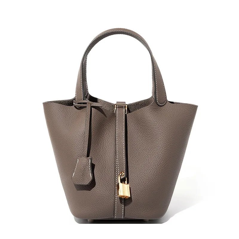 Gray handbag with a gold lock on a white background