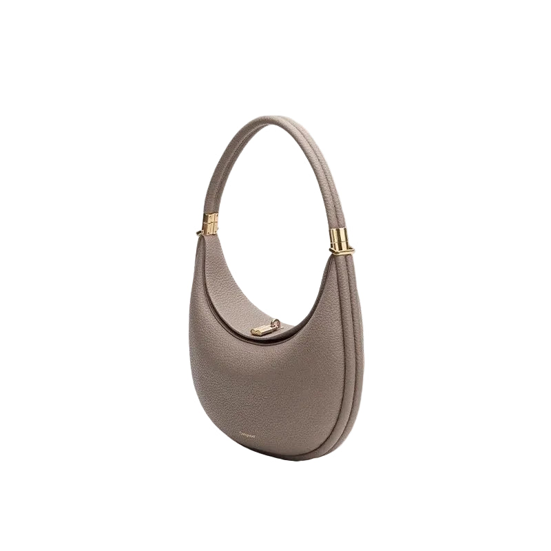 Gray handbag with gold accents on a light white background