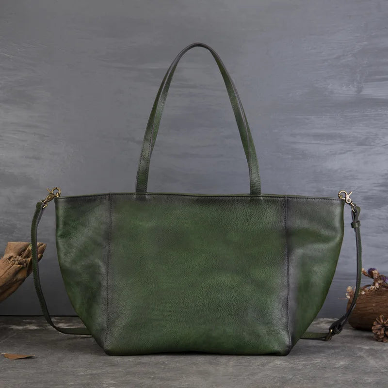 Green leather handbag on a gray background