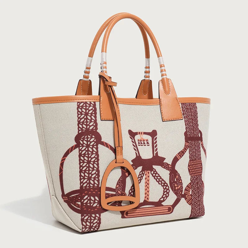 Handbag with brown leather accents and horse-related design on a light background