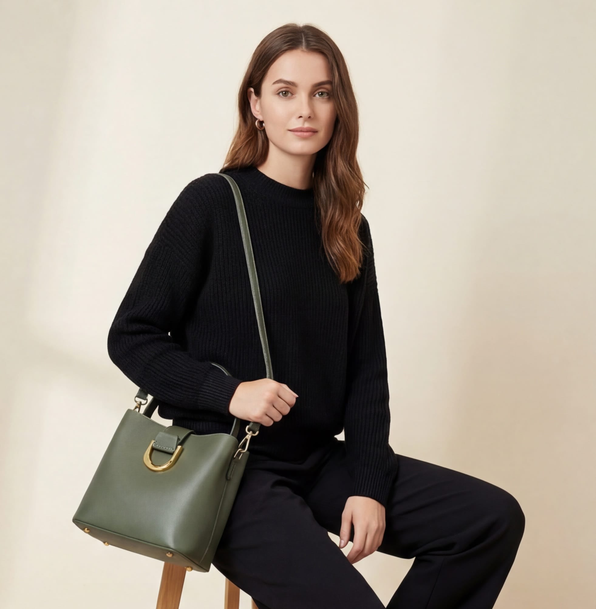 Woman holding a green handbag against a beige background