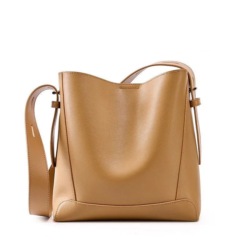 Tan leather handbag on a white background