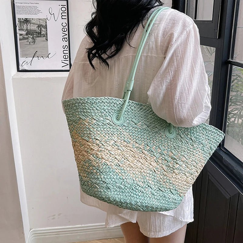 Person holding a green and beige woven bag indoors
