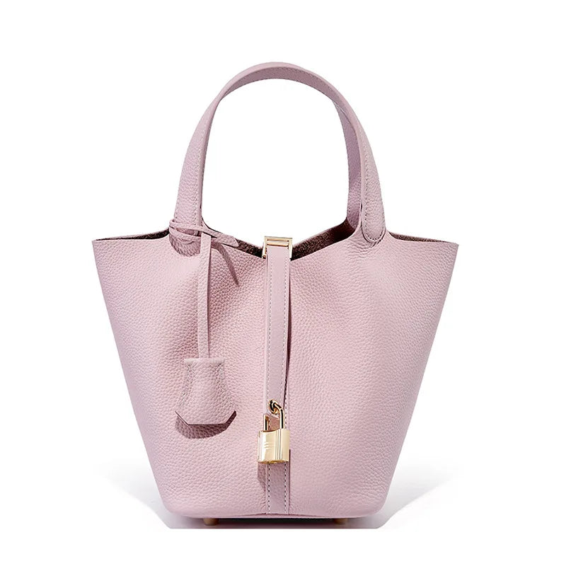 Pink handbag with a gold clasp on a white background