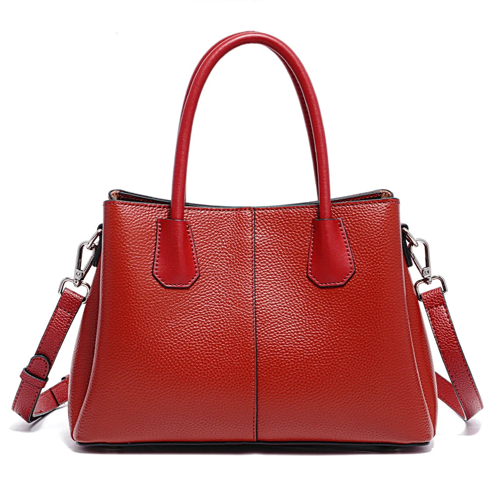 Red handbag with a strap on a white background