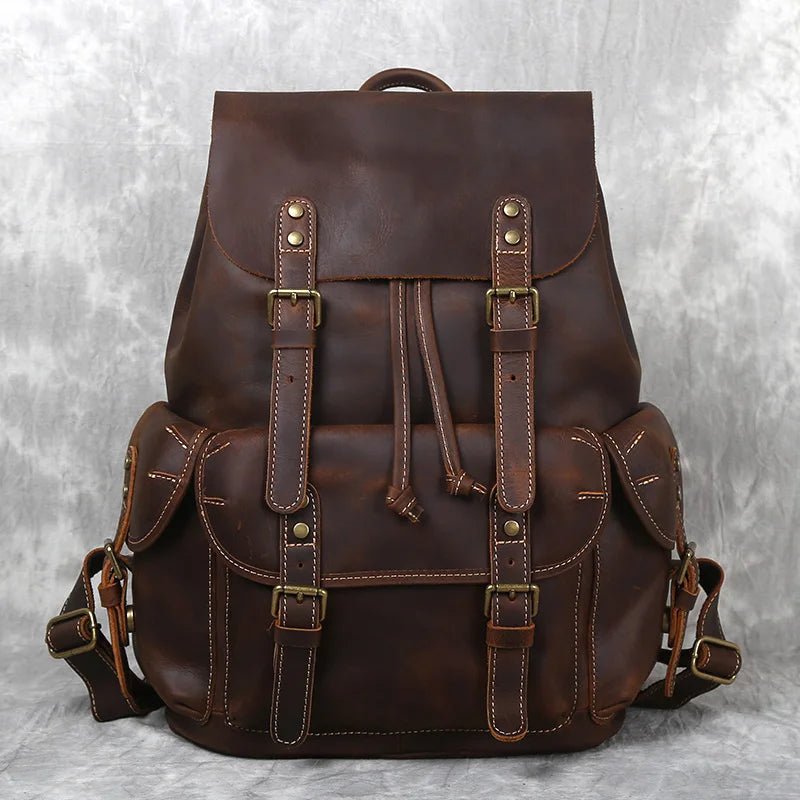 Brown leather backpack on a textured gray background