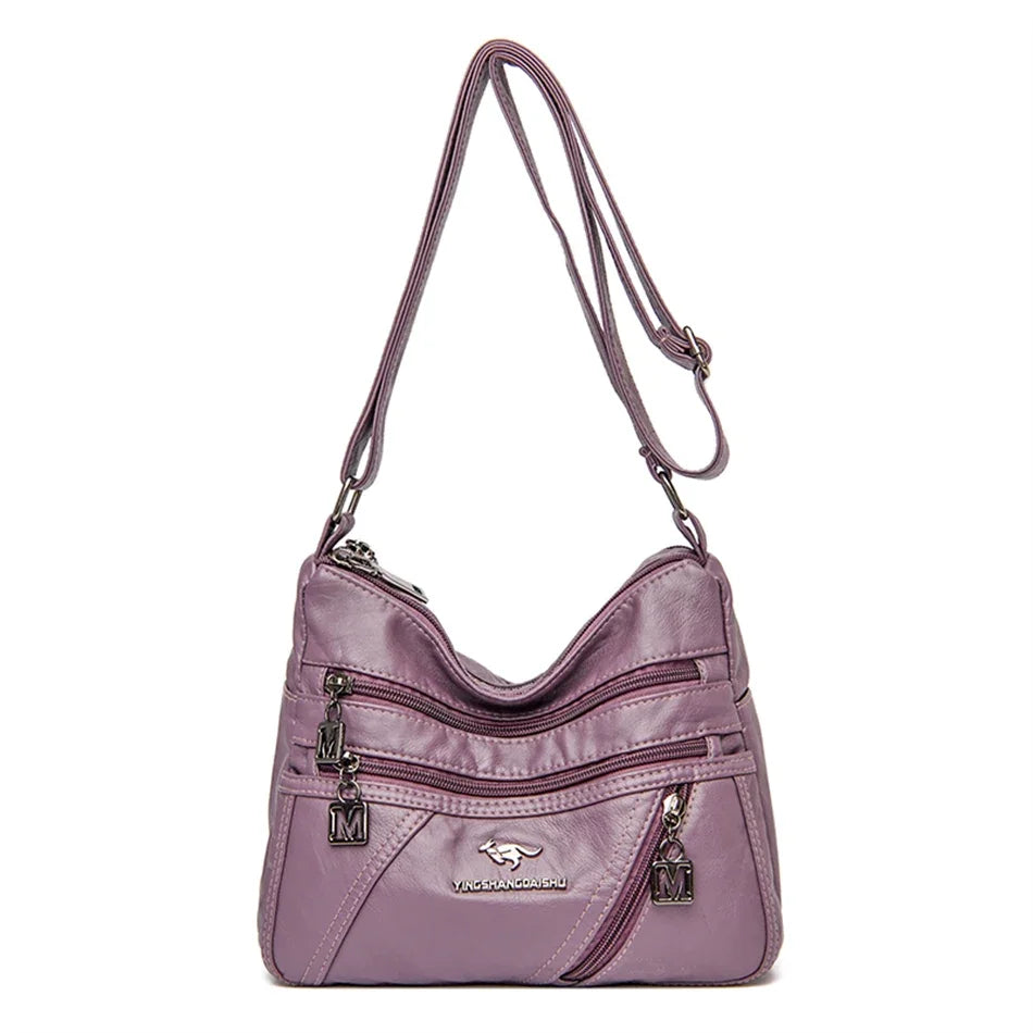Trendy purple leather crossbody purse with a sleek finish, perfect for casual or formal outfits.