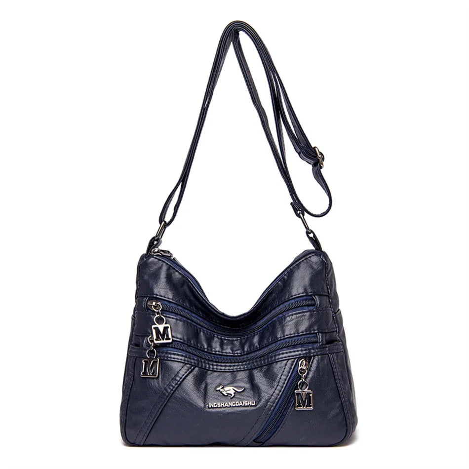 Elegant dark blue leather crossbody bag with multiple pockets, an adjustable strap, and durable stitching – perfect for daily use.