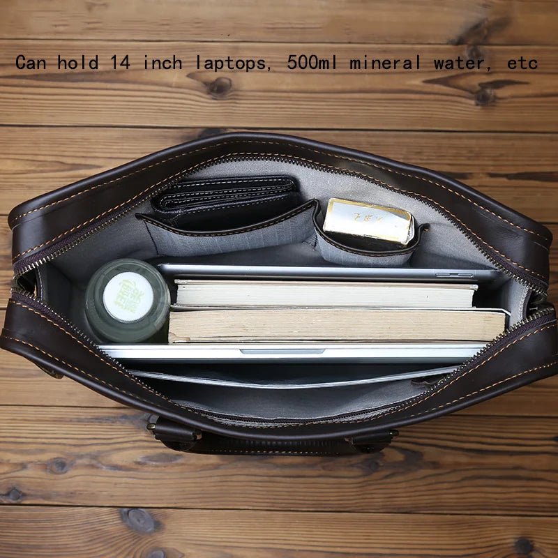 Brown leather briefcase with compartments on a wooden surface