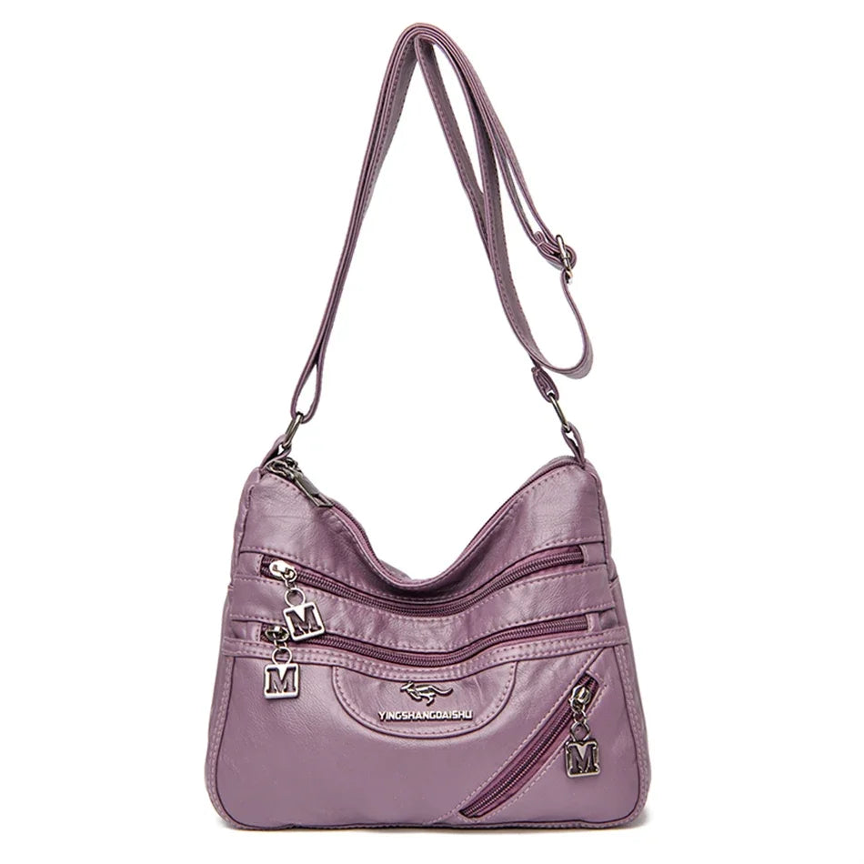 Trendy purple leather crossbody purse with a sleek finish, perfect for casual or formal outfits.