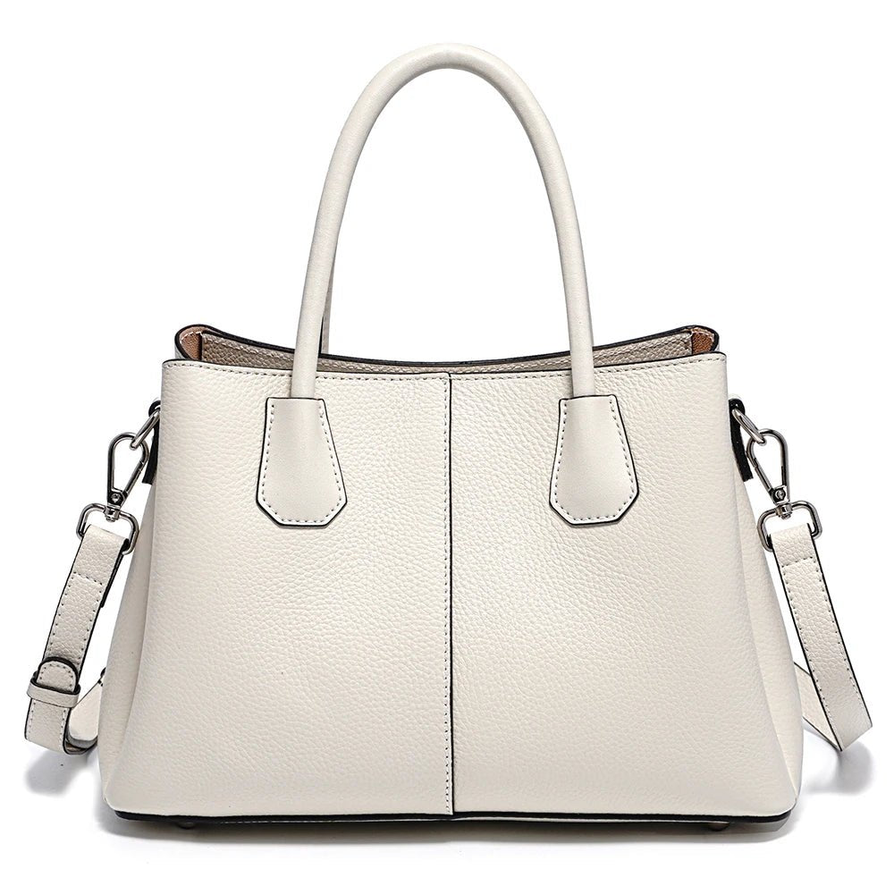 White handbag with a shoulder strap on a white background