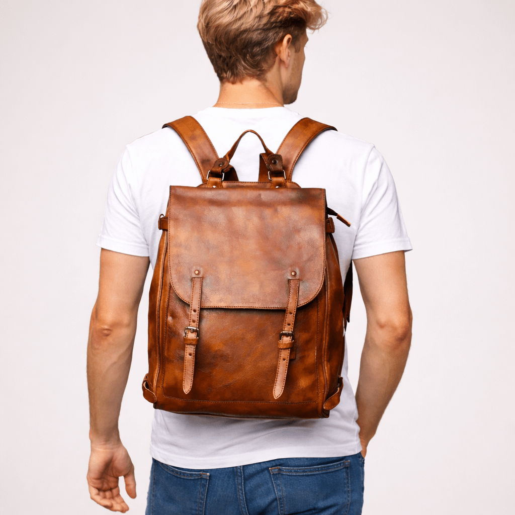 blonde men holding brown leather backpack