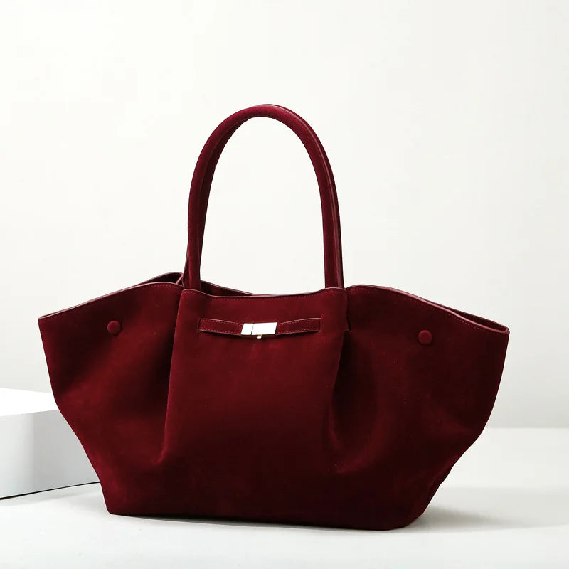 Burgundy suede tote bag with a structured silhouette and top handles