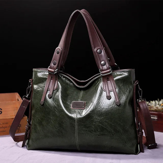 Glossy dark green leather tote bag with brown handles and a detachable shoulder strap, displayed against a black background.