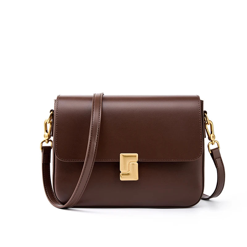 Brown leather handbag with gold accents on a white background