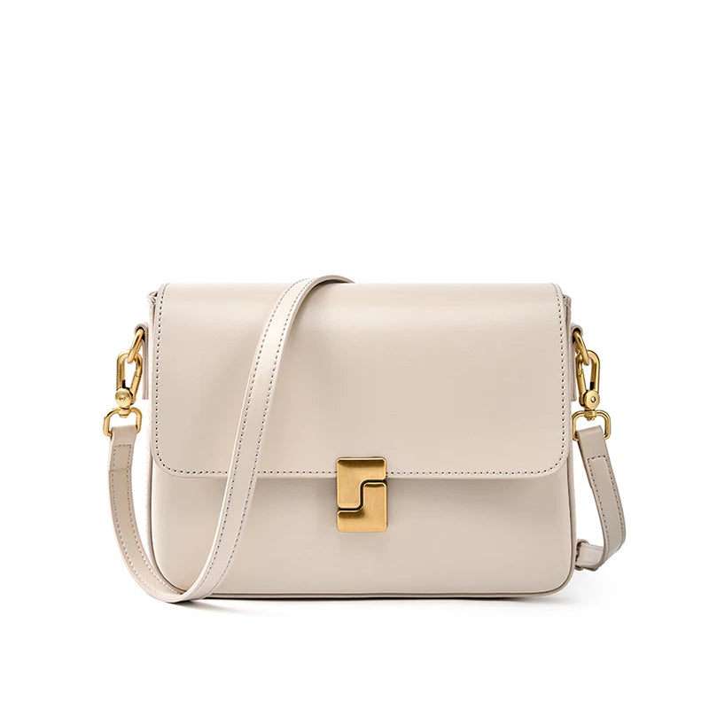 Beige handbag with gold clasp and chain strap on a white background