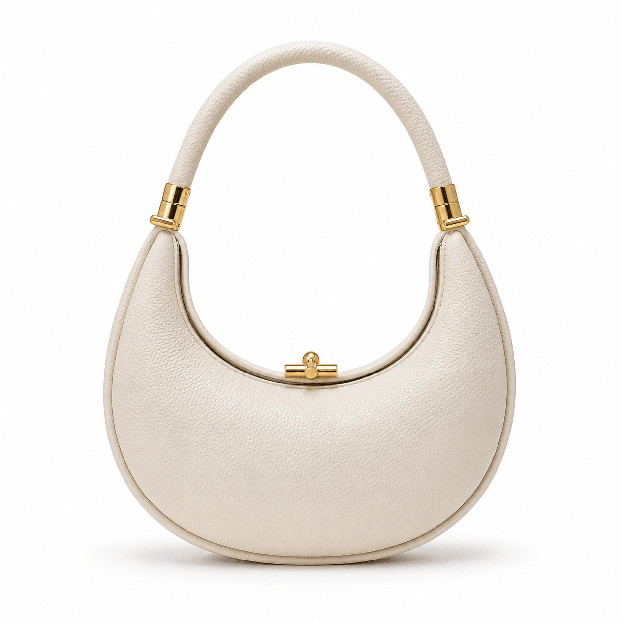 Ivory handbag with gold accents on a white background